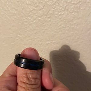 A man’s ring with Thin blue line A black around it